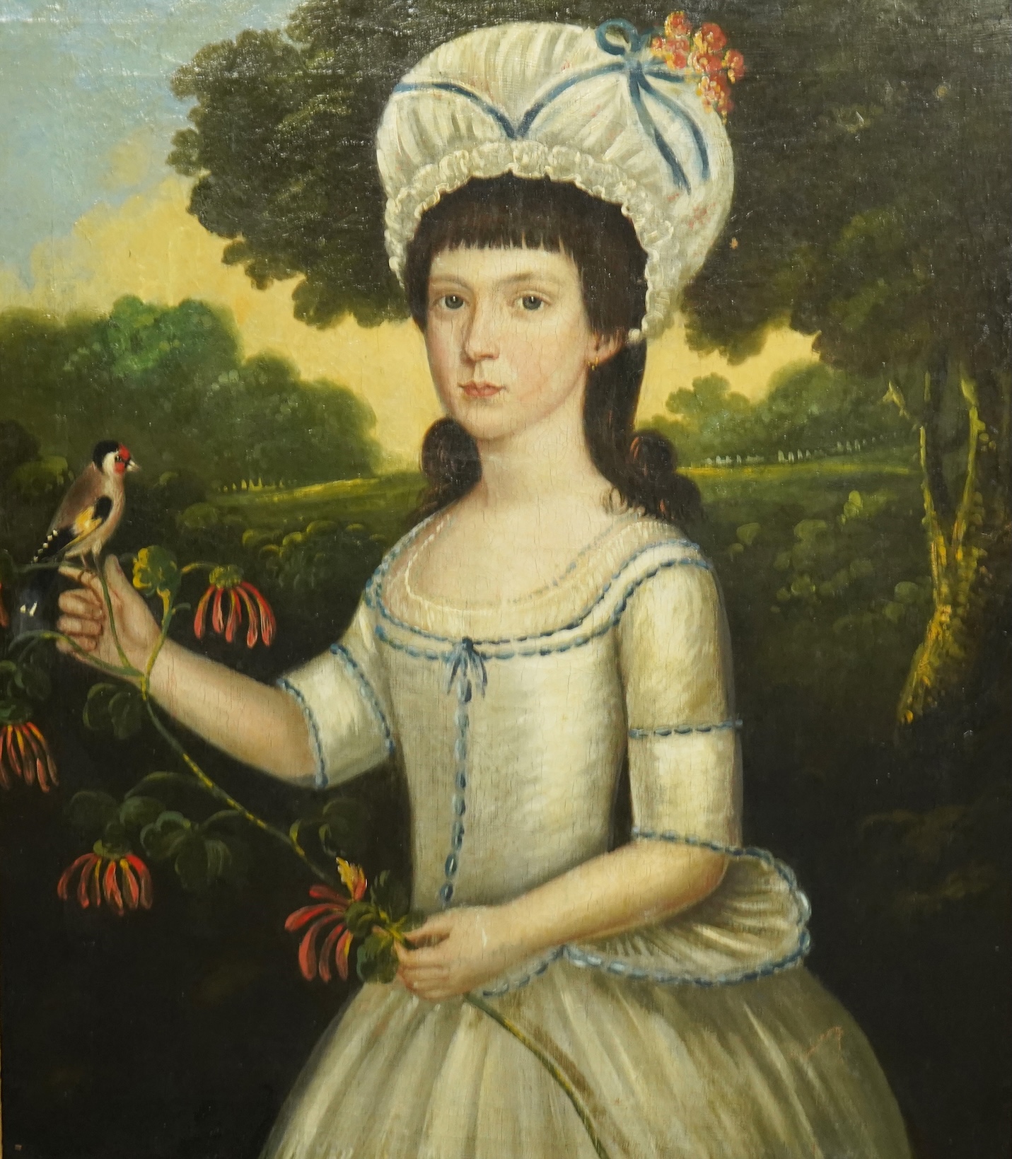 Late 18th century English School, Half length portrait of a young woman, standing in a landscape holding a goldfinch, oil on canvas, 74 x 46cm